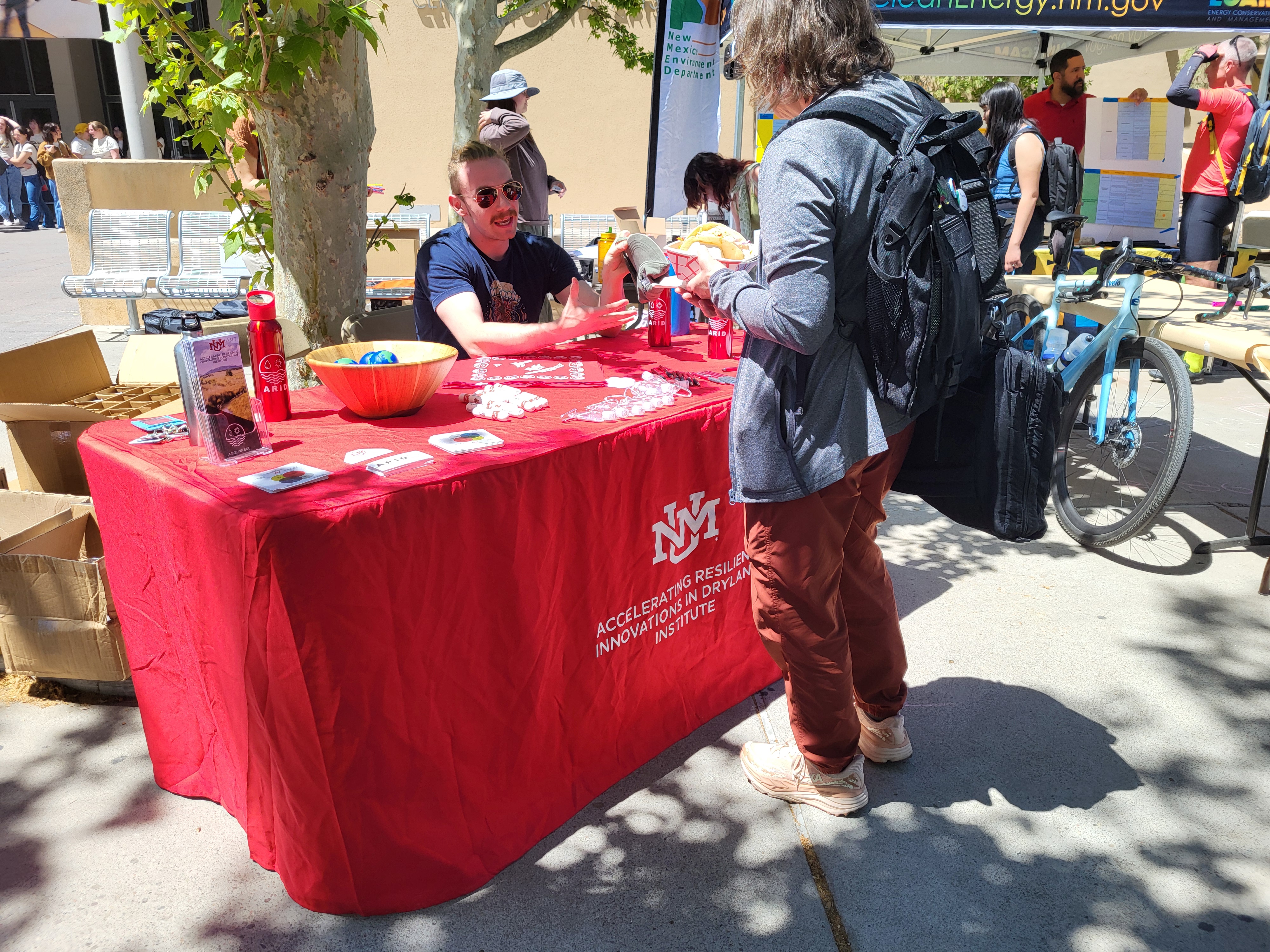 ARID graduate student Wyatt Donner engaging with a community member at the 2025 Sustainability Expo